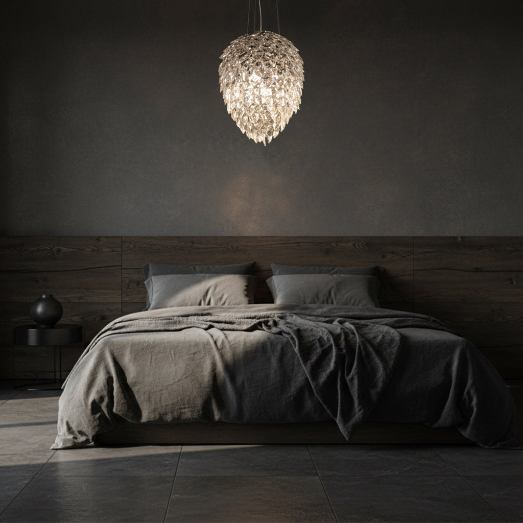 Dark bedroom with a bed and a large crystal pendant light fixture.