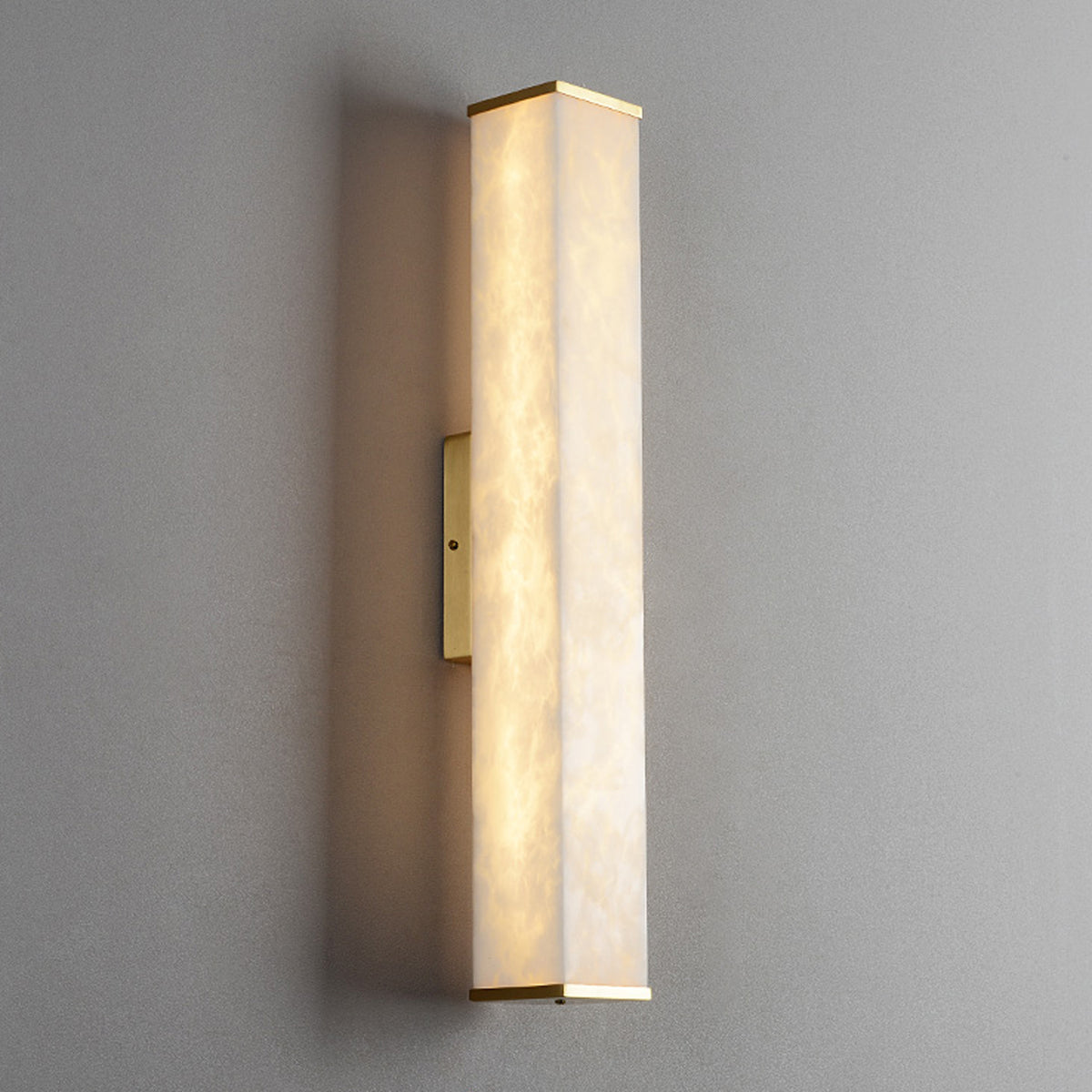 Modern wall sconce light fixture on a gray wall