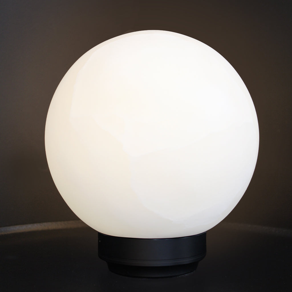 A spherical stone globe lamp with a matte black metal base, shown illuminated against a dark background.