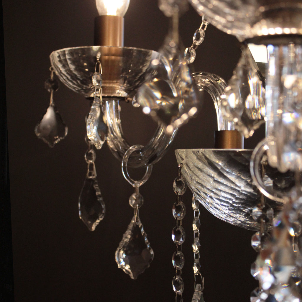 Close-up of a chandelier with crystal elements against a dark background