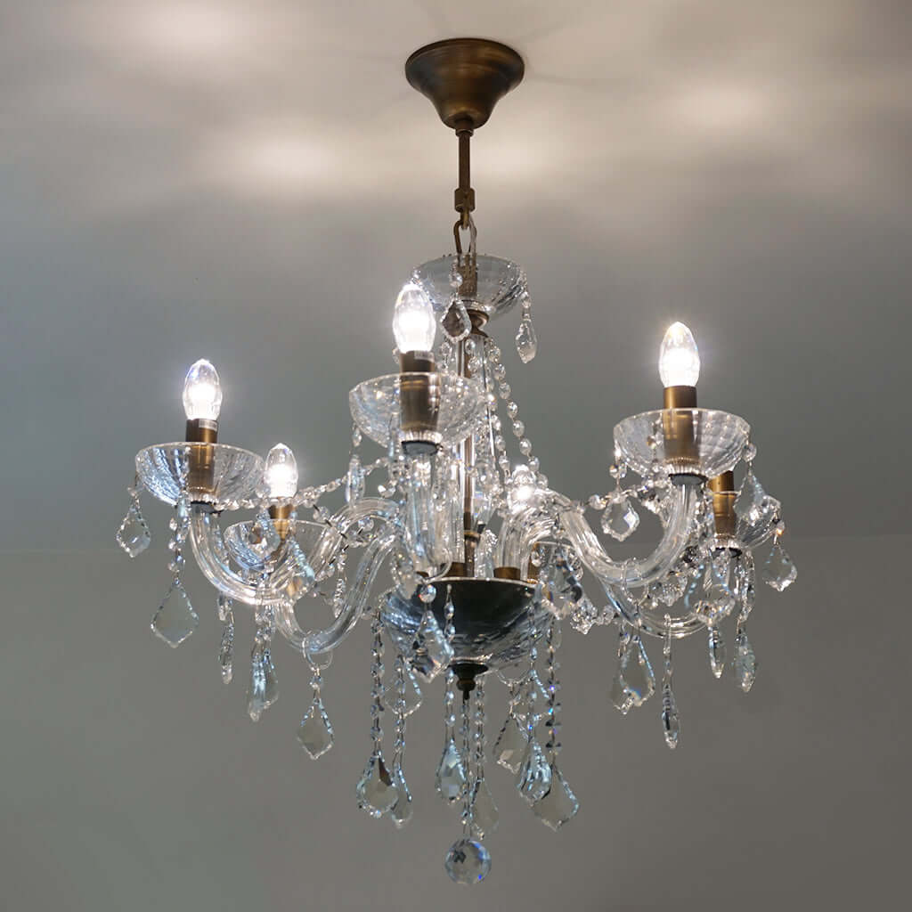 Crystal chandelier with multiple lights on a gray background