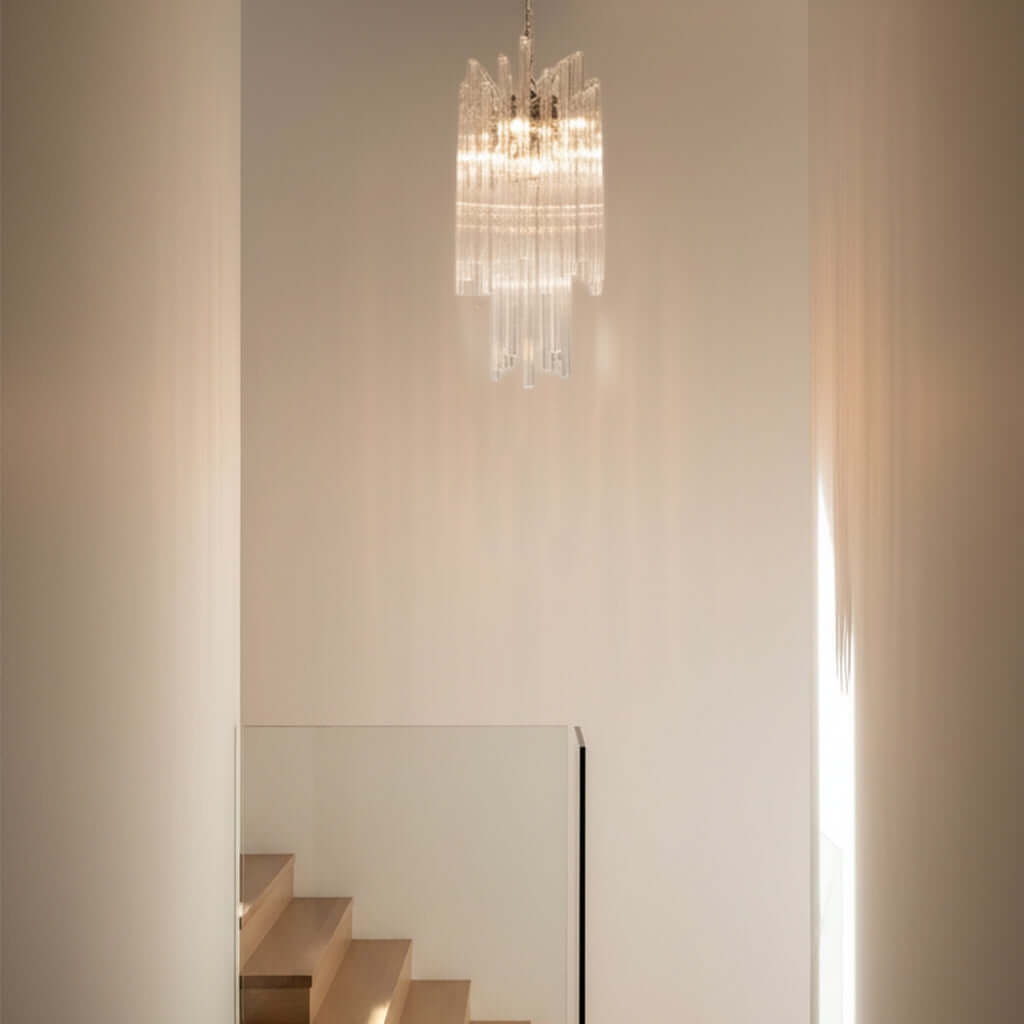 Chandelier hanging above a staircase in a softly lit room