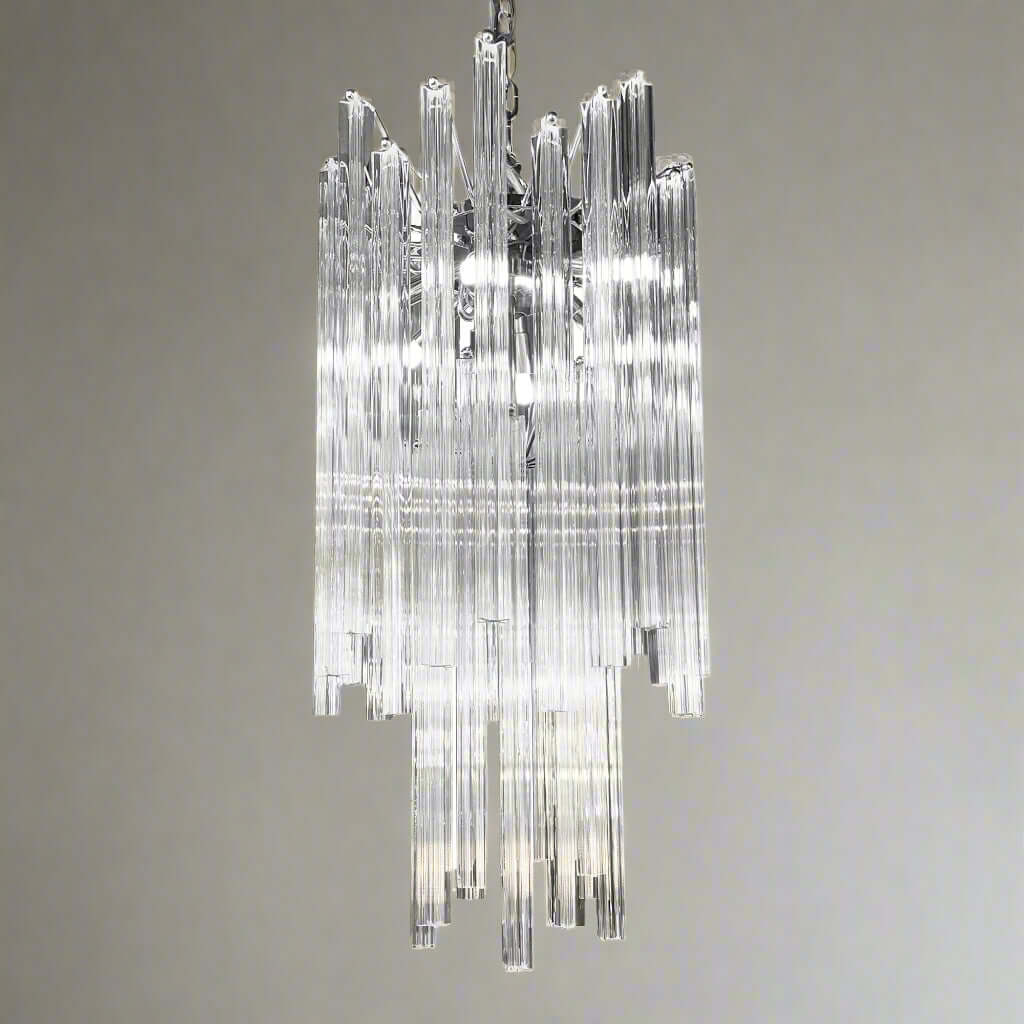 A chrome-finished pendant light fixture with clear prism glass rods arranged in a tiered structure, designed in an art deco style.