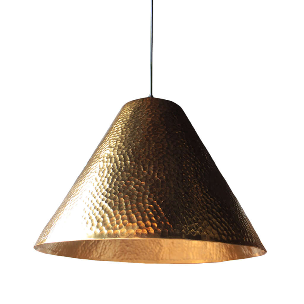Hammered gold pendant light on a white background