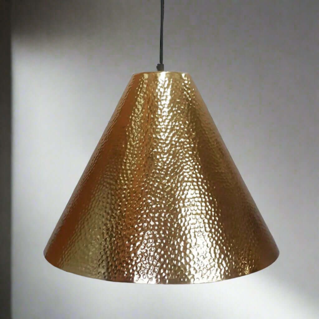 Gold pendant light with a textured surface on a plain background