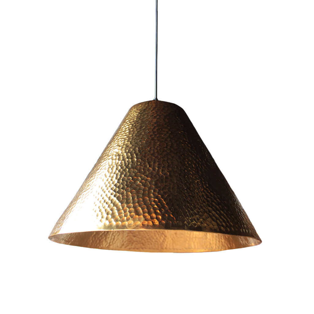 Hammered gold pendant light on a white background