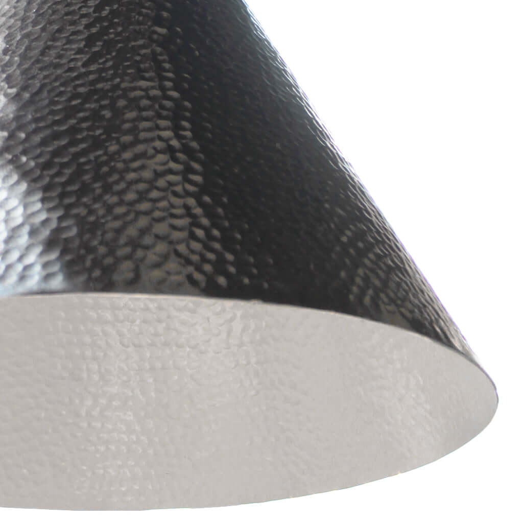 Close-up of a textured silver and white lampshade on a white background