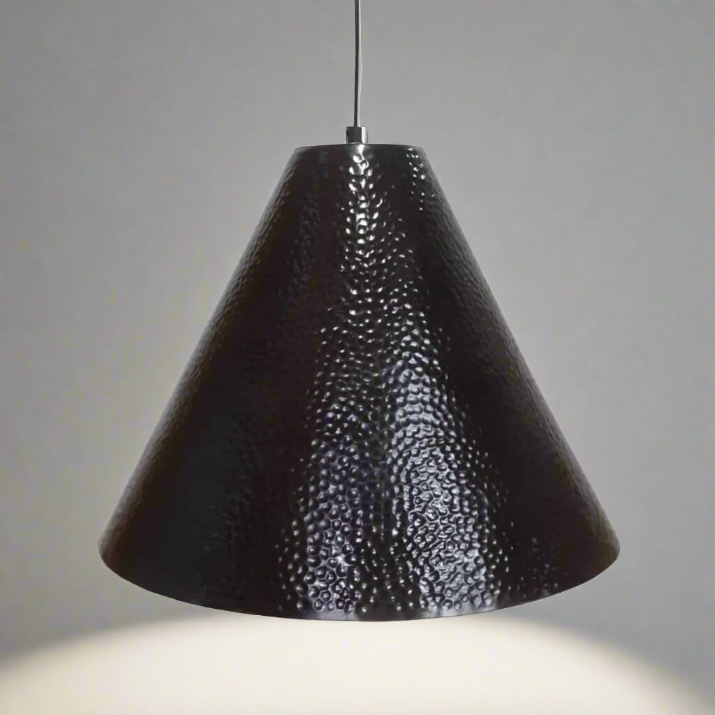 Black textured pendant light against a gray background