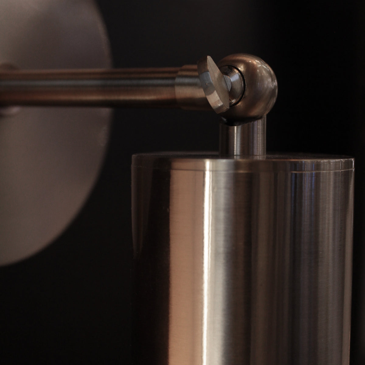 Close-up of a wall light detail with a dark background