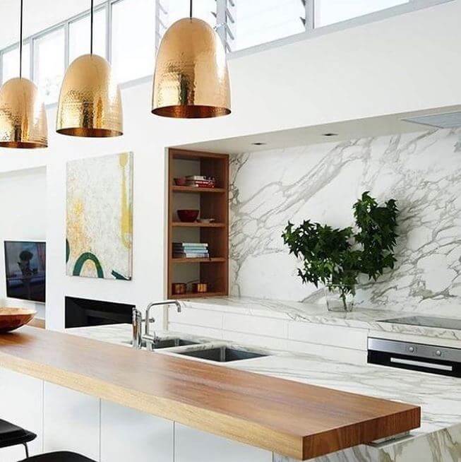 Handbeaten brass pendants over kitchen island