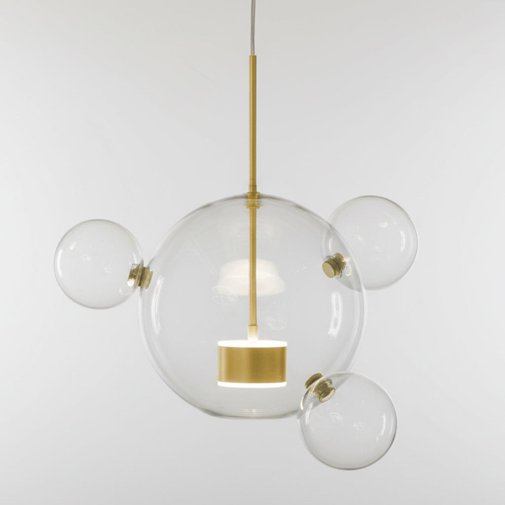 Modern pendant light with clear glass spheres and gold accents on a white background