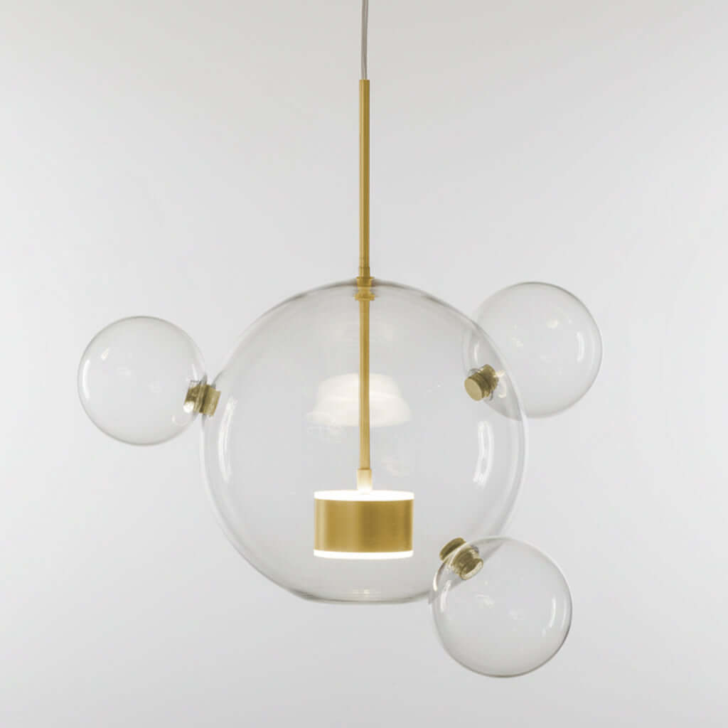 Modern pendant light with clear glass spheres and gold accents on a white background