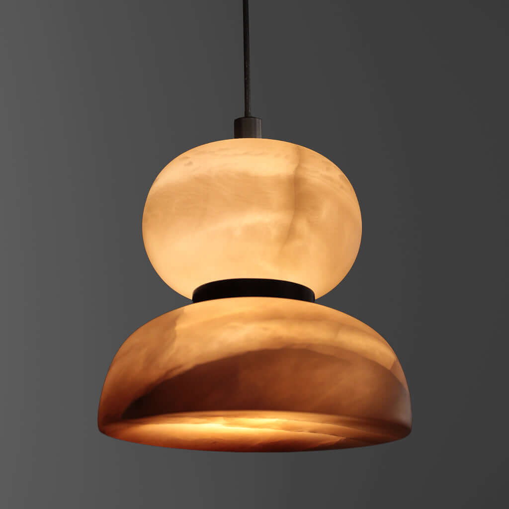 Modern pendant light with a warm glow on a dark background