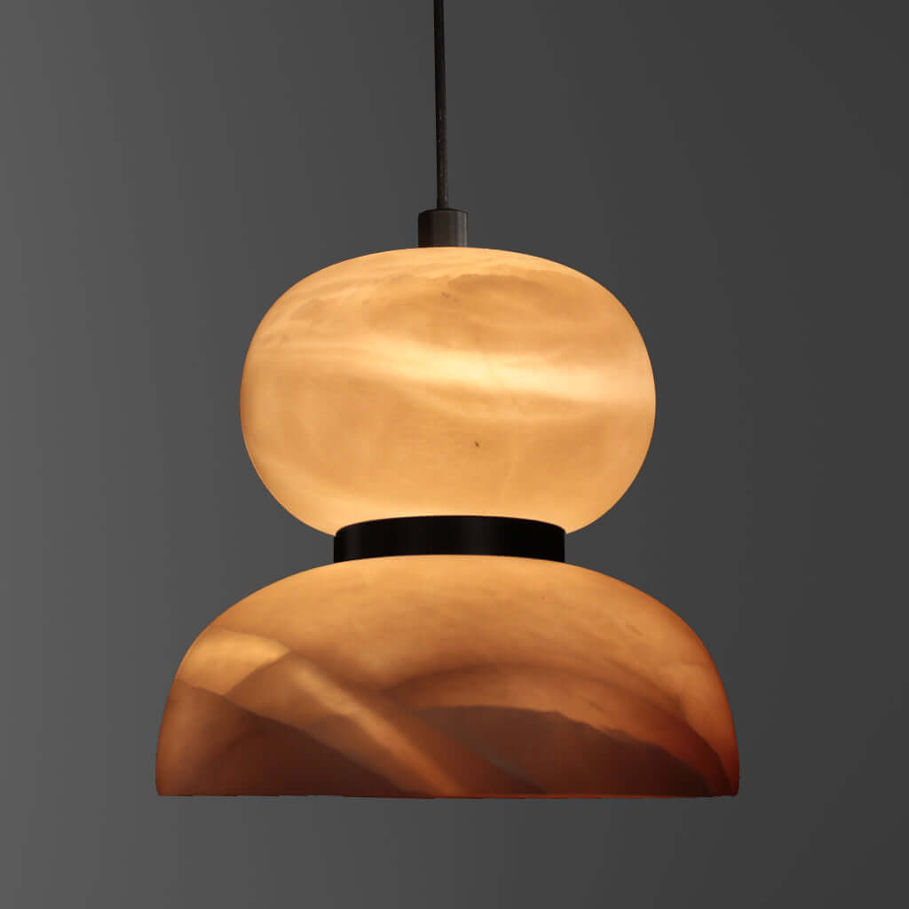 Modern pendant light with a warm glow on a dark background