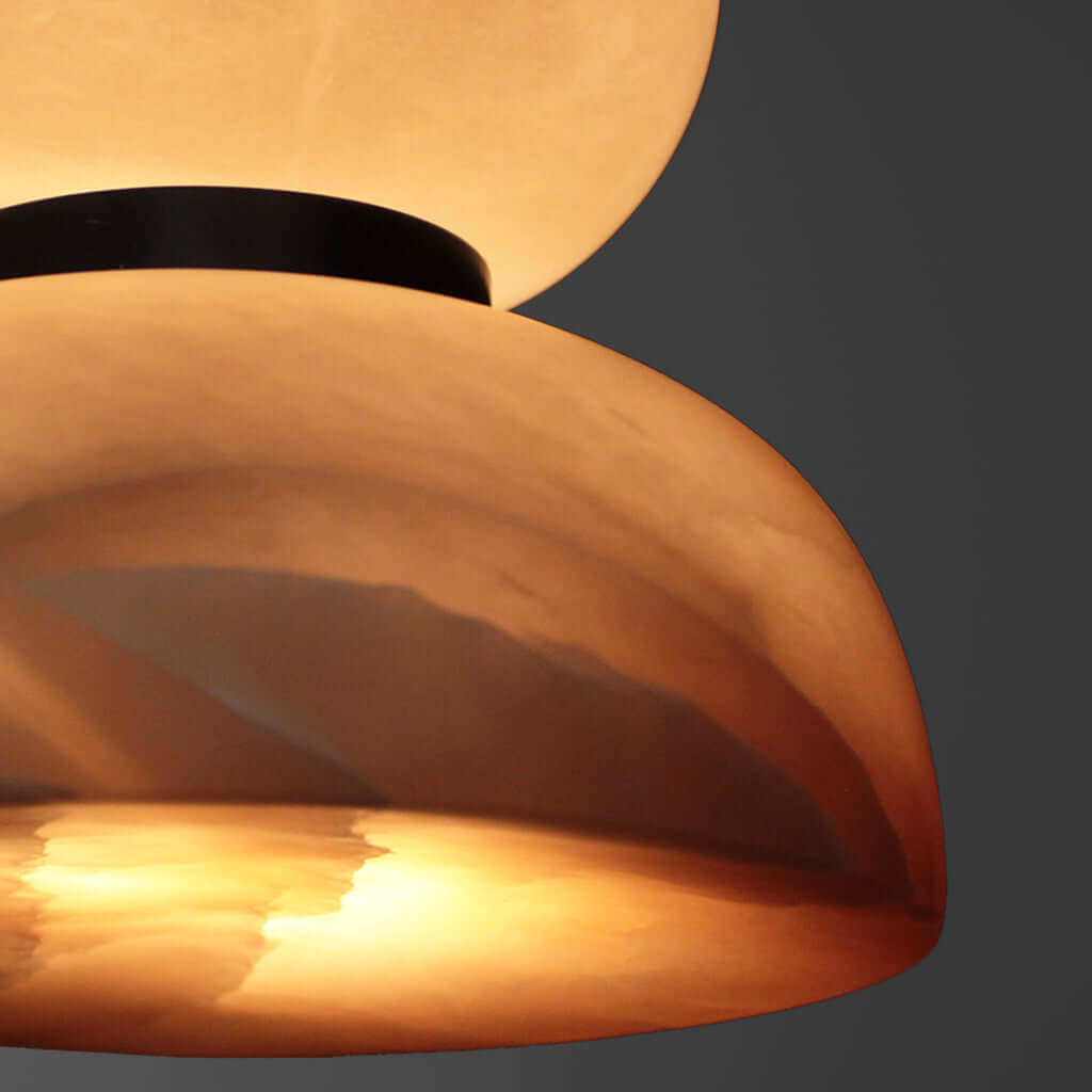 Close-up of a stone pendant light against a dark background
