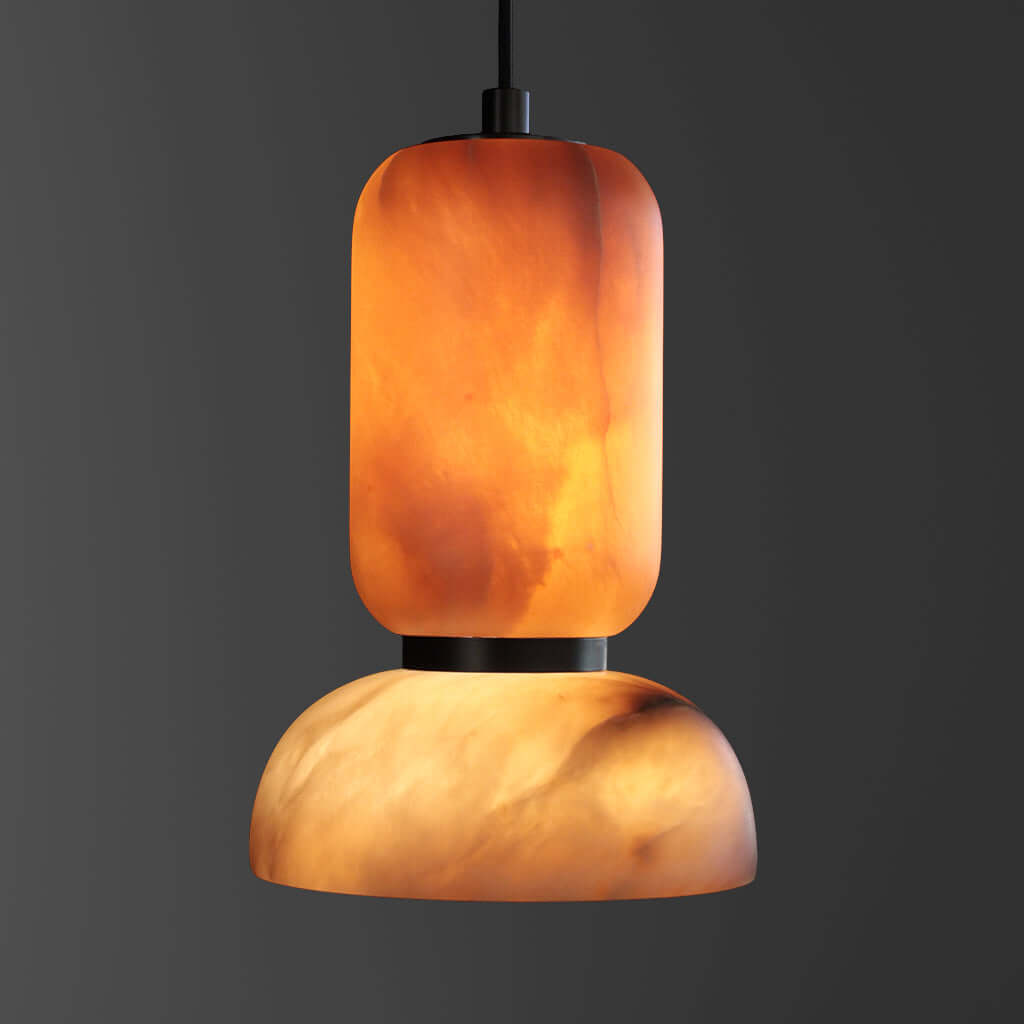 Pendant light with a warm, orange-brown stone shade on a dark background