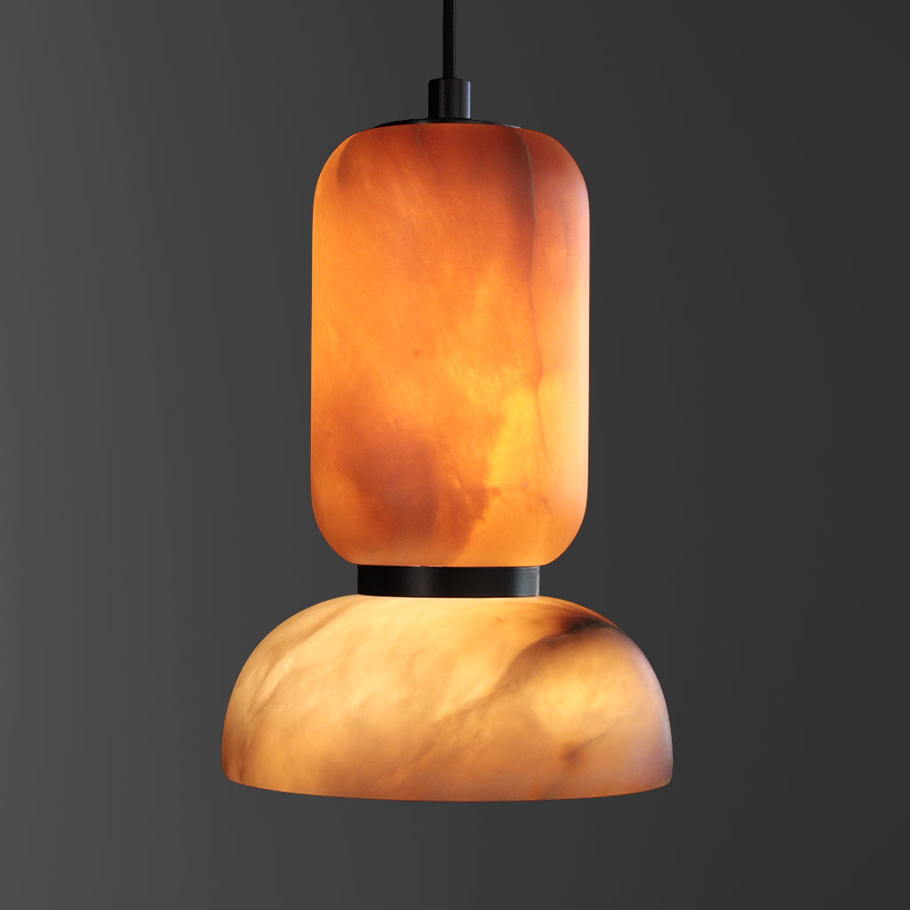Pendant light with a warm, orange-brown stone shade on a dark background