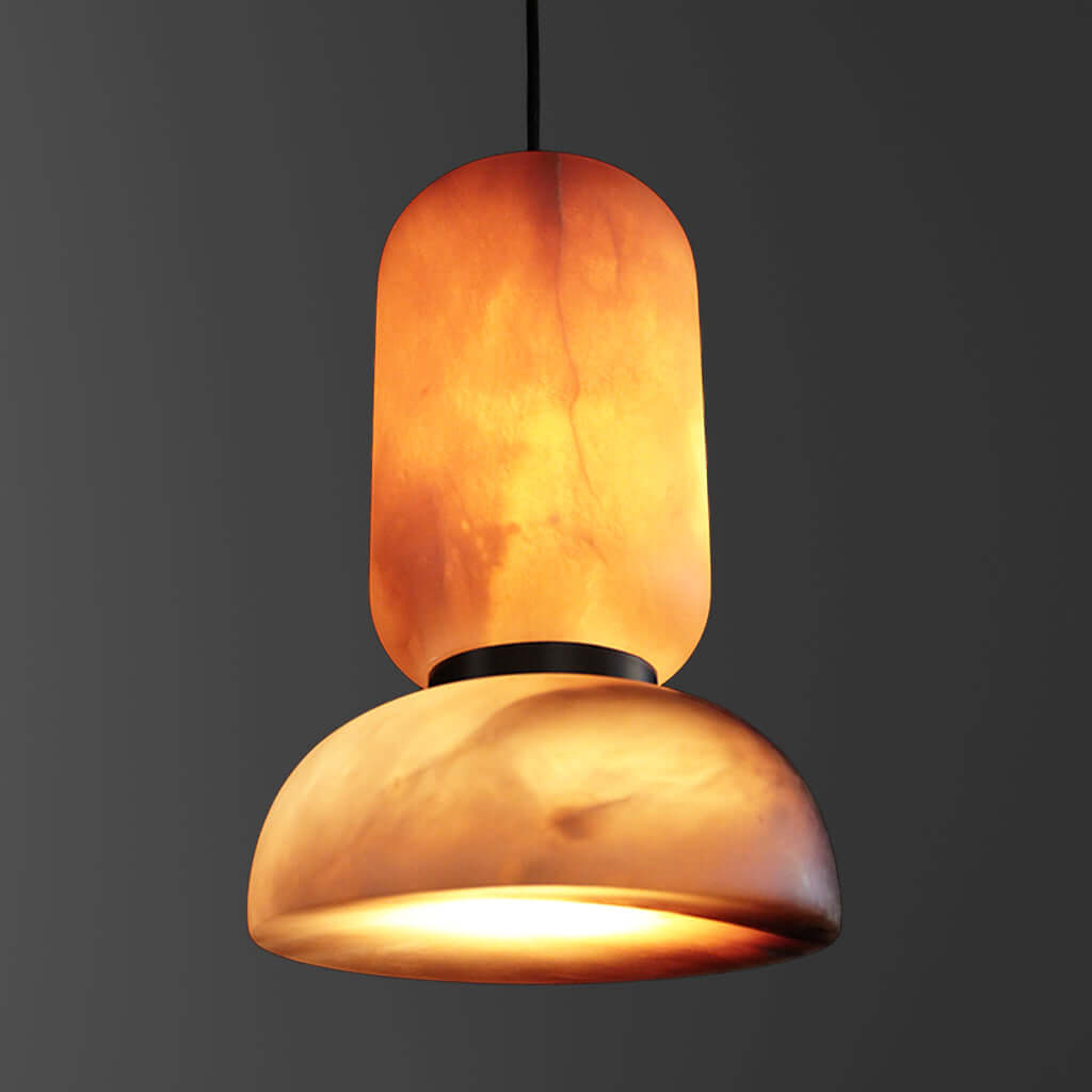 Pendant light with a warm, orange-brown stone shade on a dark background