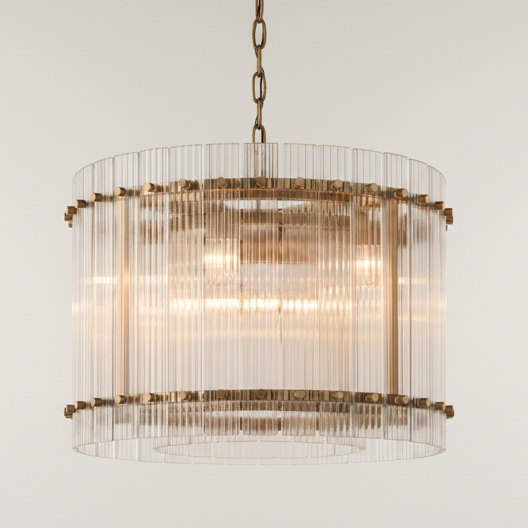Chandelier with glass and brass design on a light gray background