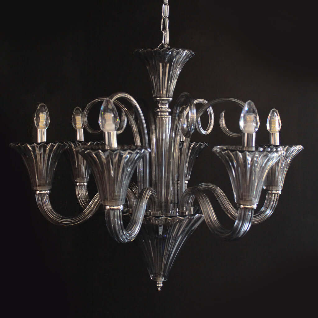 Decorative chandelier with smokey grey arms on a black background