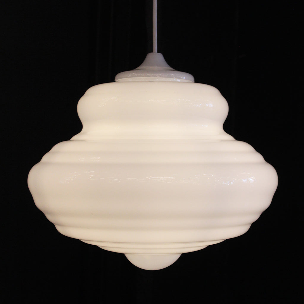 A vintage-style white ribbed glass pendant light with a matching white cord, shown against a solid black background.