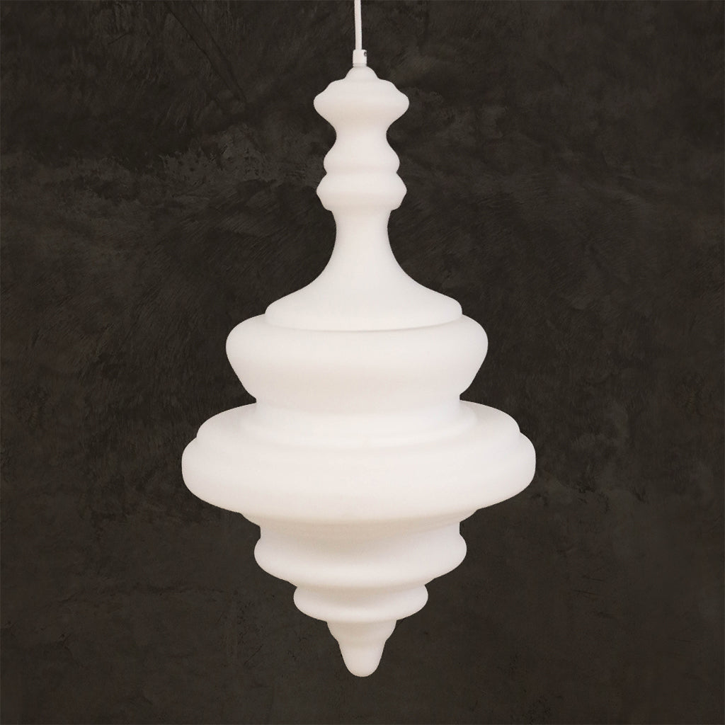 A white, sculptural pendant light with a tiered design hanging against a dark, textured background.