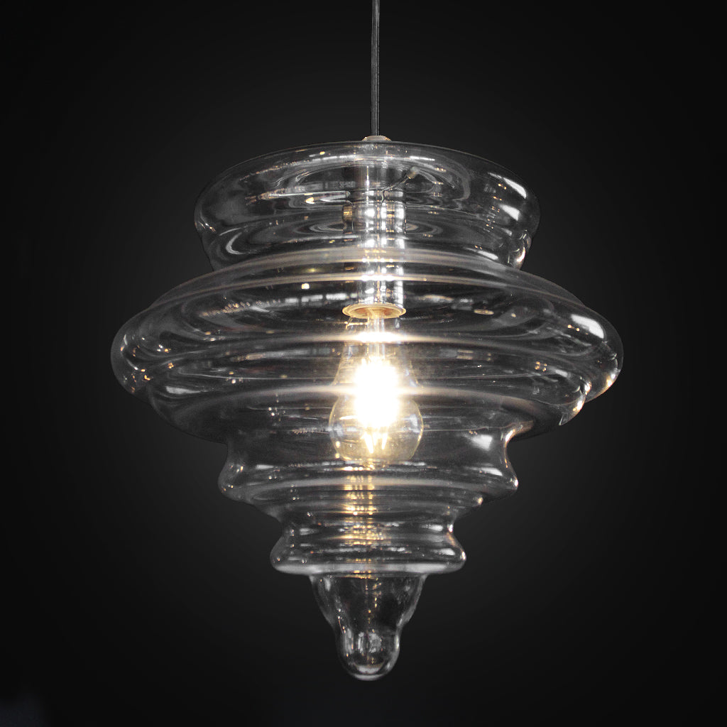 Clear glass pendant light with a dark background