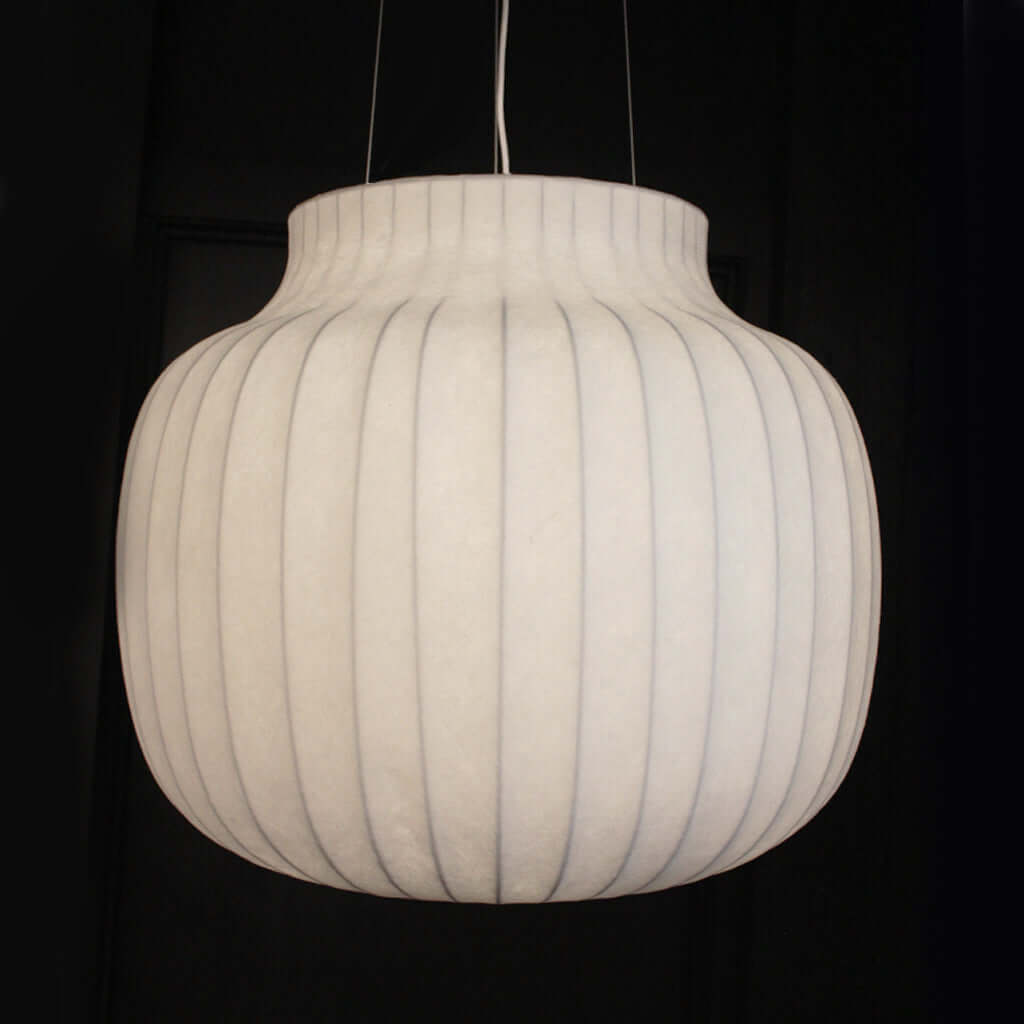White ribbed pendant light against a black background