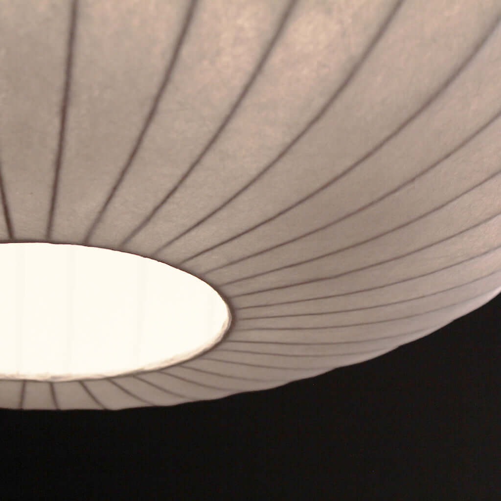 Close-up of a textured lampshade with a dark background