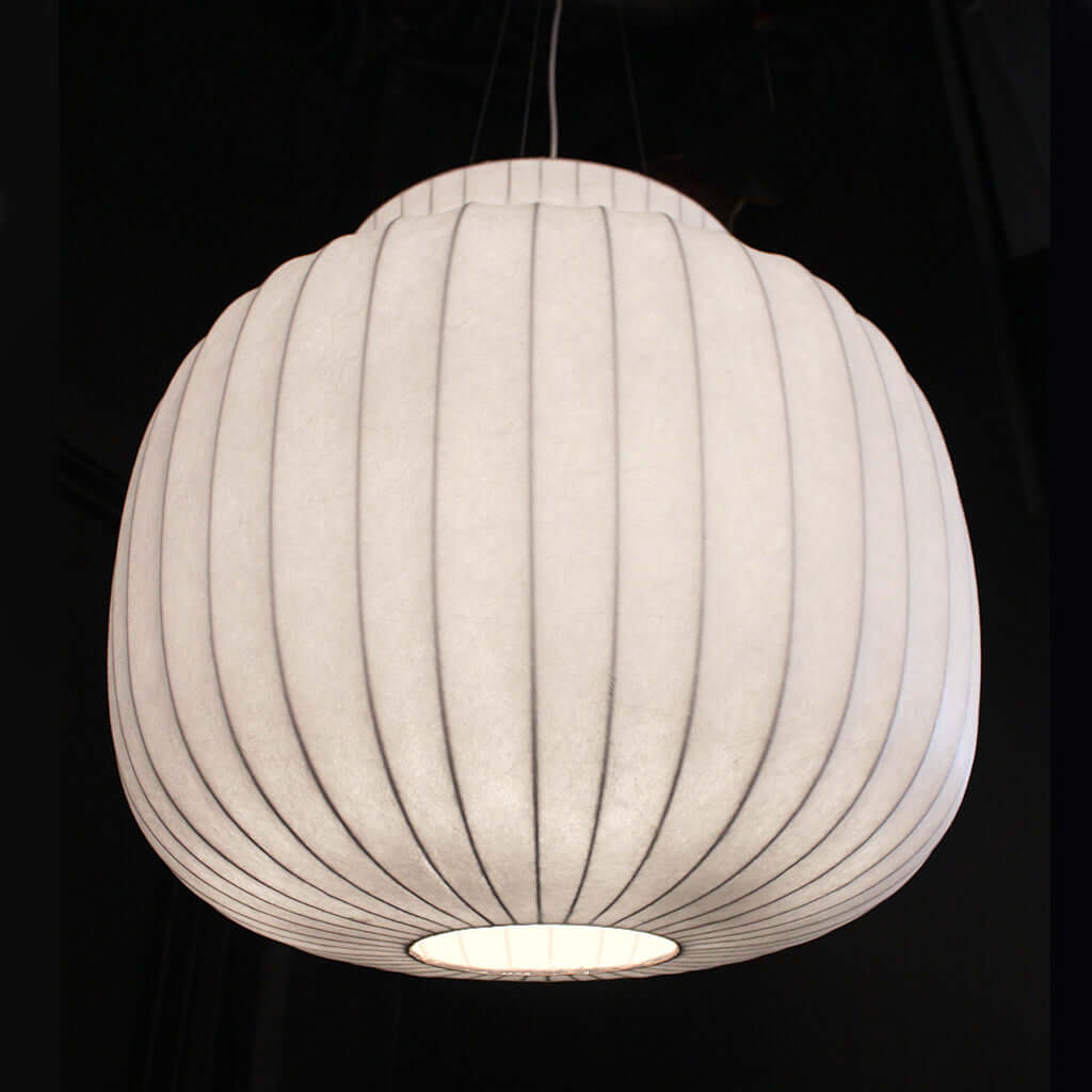 White ribbed pendant light against a black background