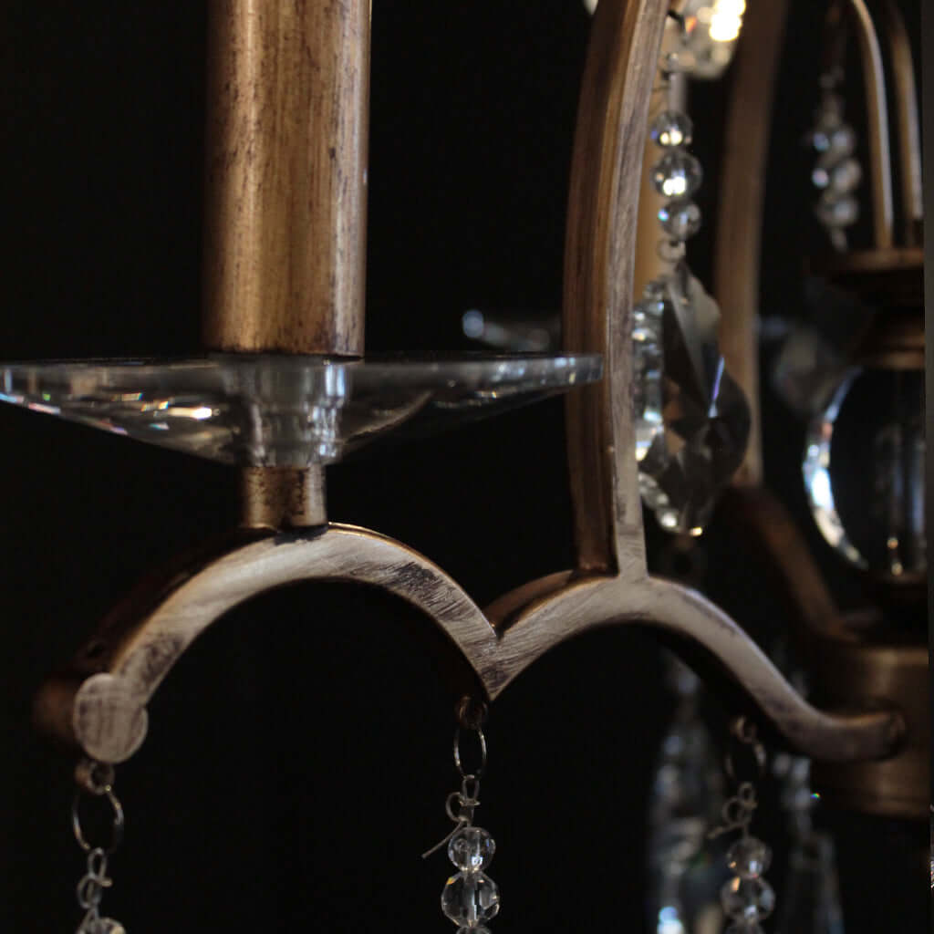 Close-up of a decorative chandelier with crystal elements on a dark background