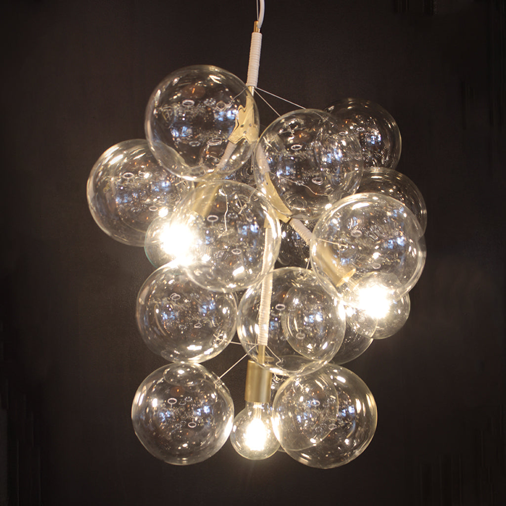 Chandelier with multiple glass bulbs on a dark background