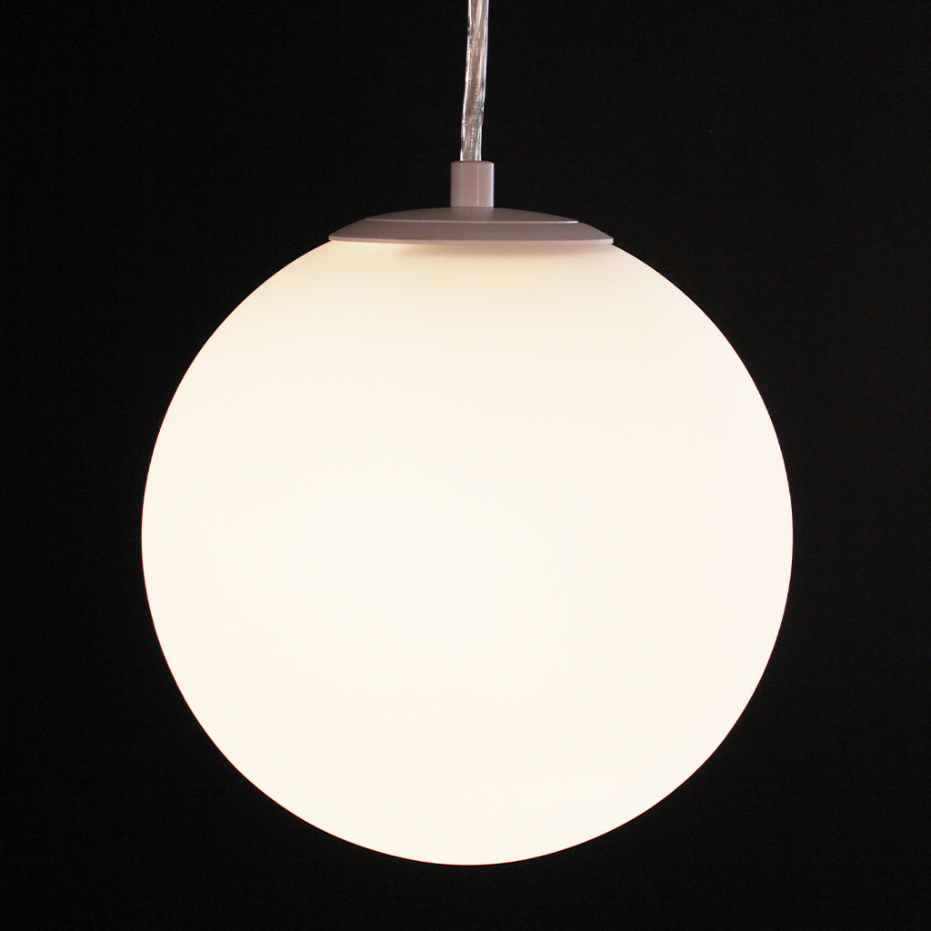 A modern spherical pendant light with a glowing frosted glass globe shade, suspended by a thin cord against a solid black background.