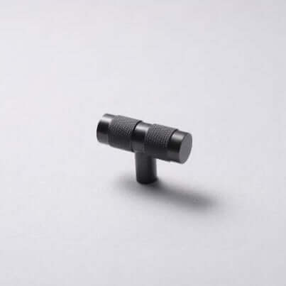 A black brass handle T-pull on a white background.