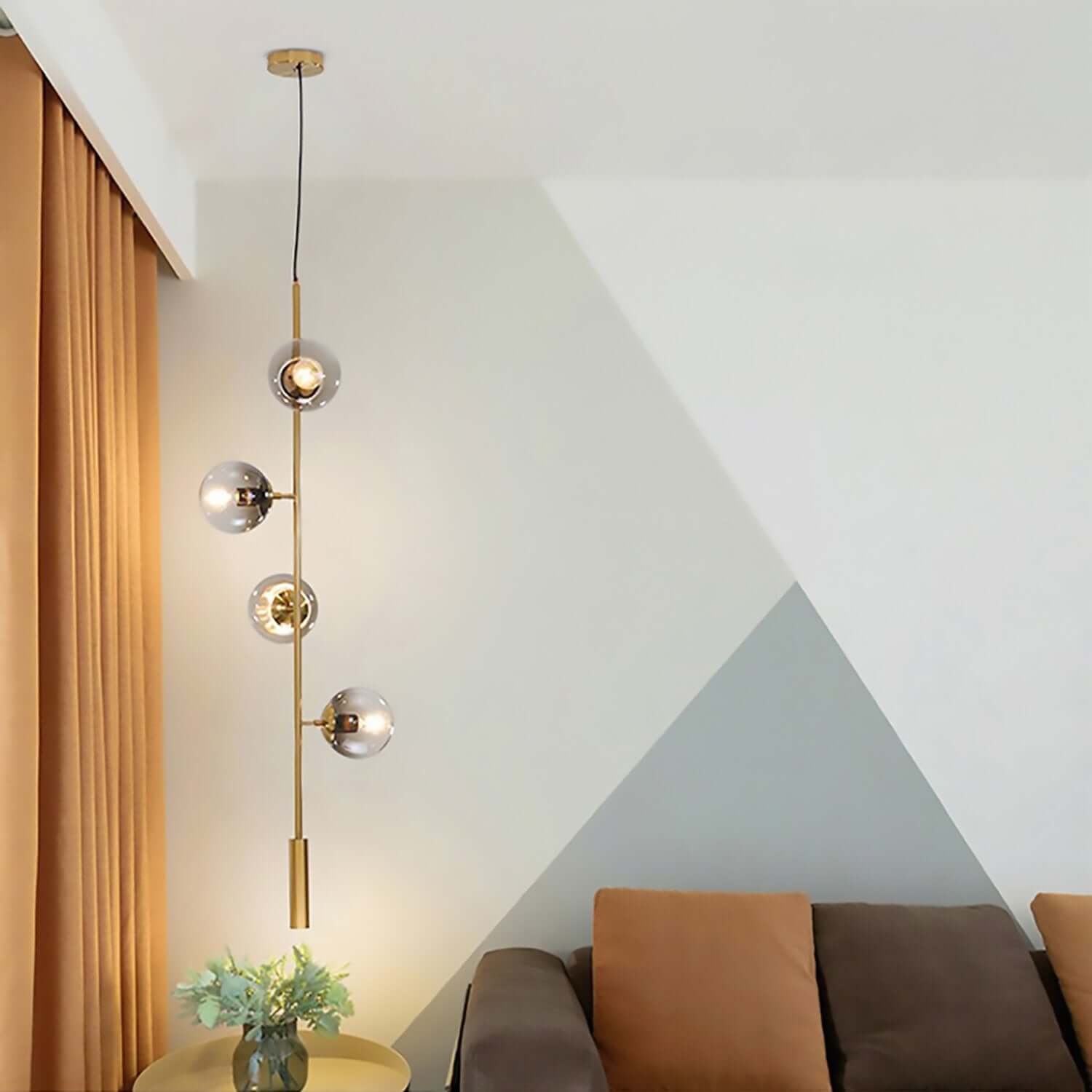 Vertical format pendant light in tall double height void space