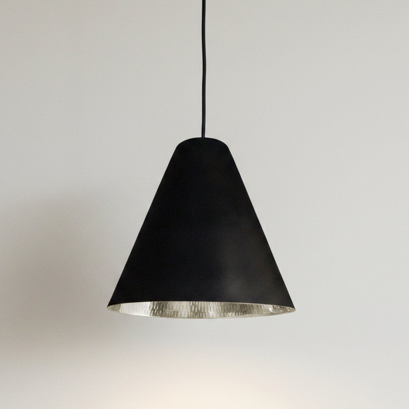 Bar counter with black and silver pendants in a dimly lit bar setting
