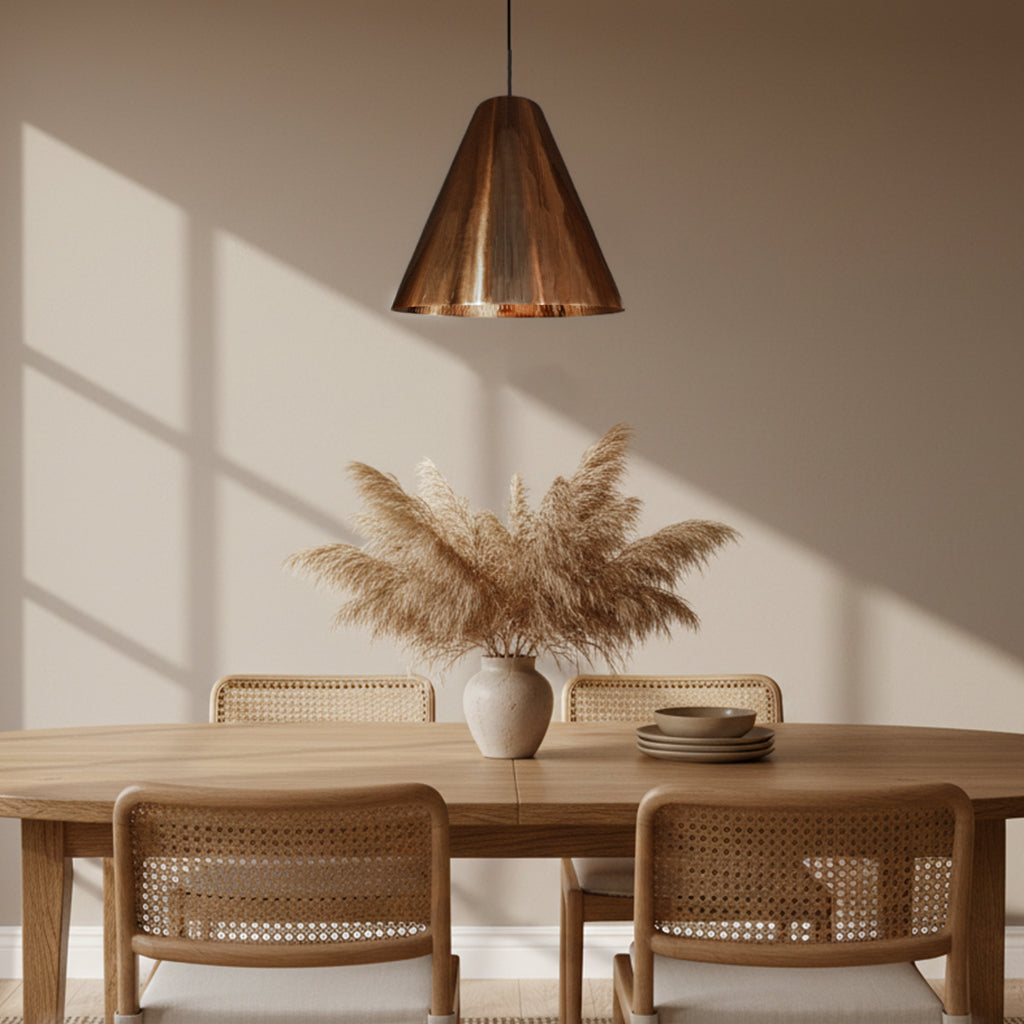 Dining room with wooden table, wicker chairs, and a copper pendant light.
