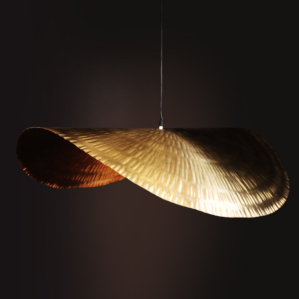 Decorative pendant light with feather-like design on a black background
