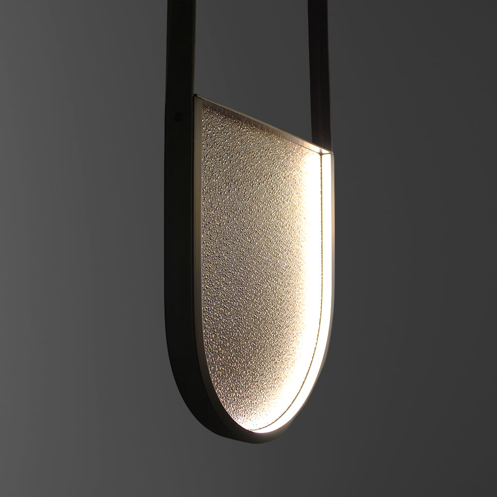 Modern pendant light with a textured shade on a dark background