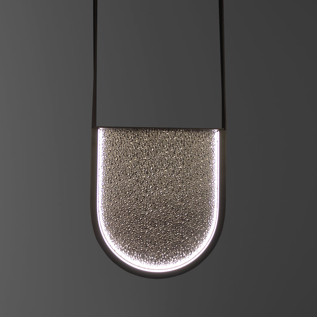 Modern pendant light fixture on a dark gray background