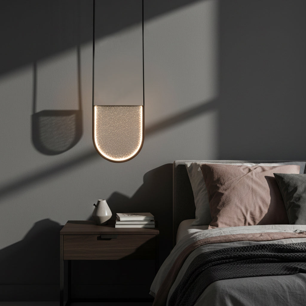 Modern pendant light fixture on a dark gray background