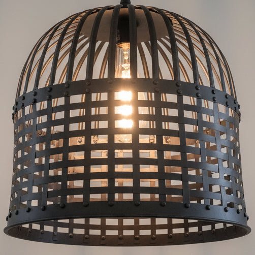 Woven metal pendant light fixture with a glowing bulb inside.