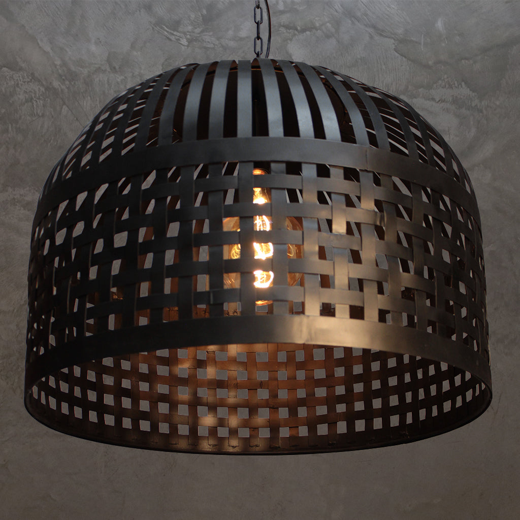 Decorative pendant light with woven design on a textured wall background