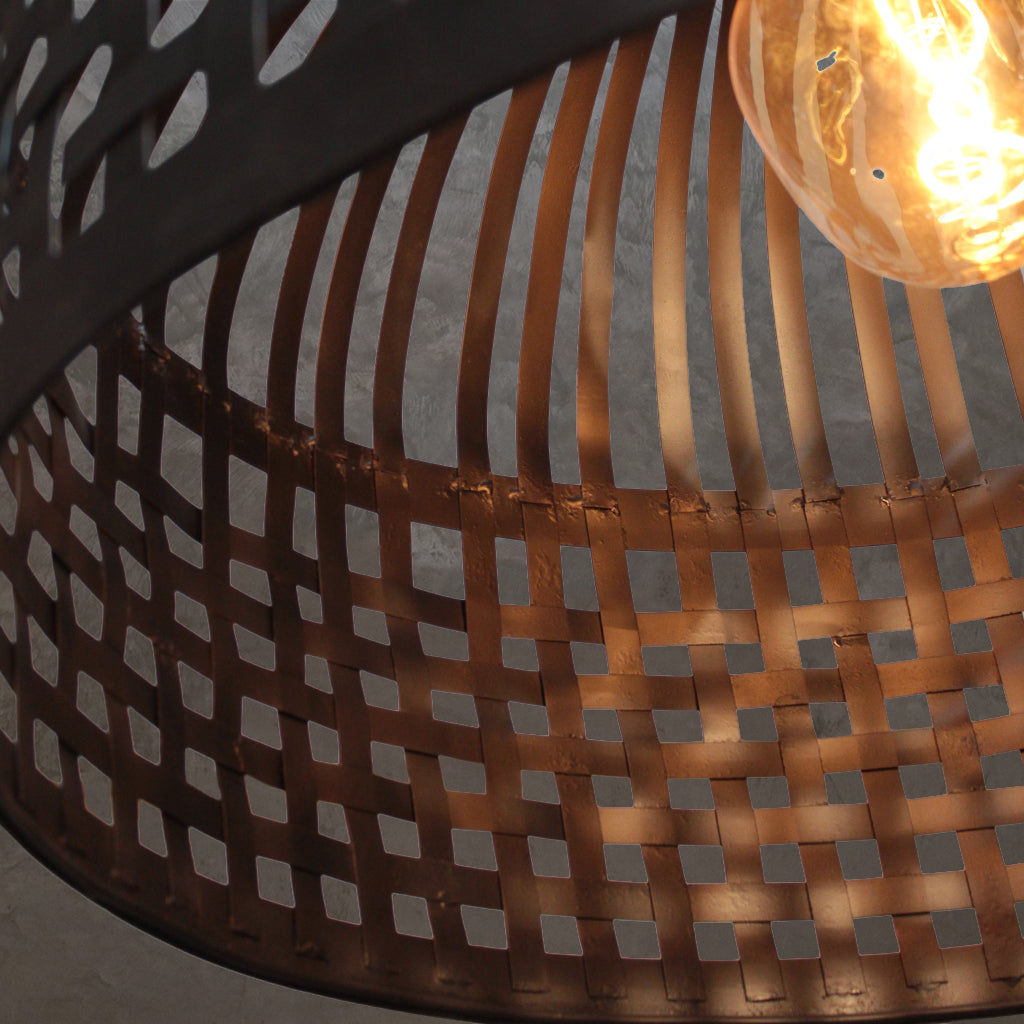 Close-up of a woven basket with a light bulb inside, on a neutral background