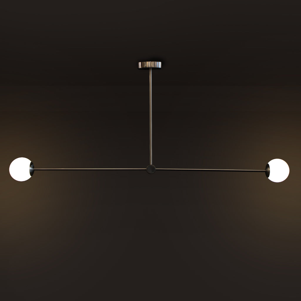 Modern minimalist two-light linear chandelier with spherical white globe bulbs on a dark background.