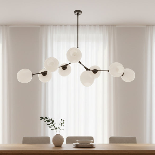 Modern chandelier with multiple round glass shades on a white background