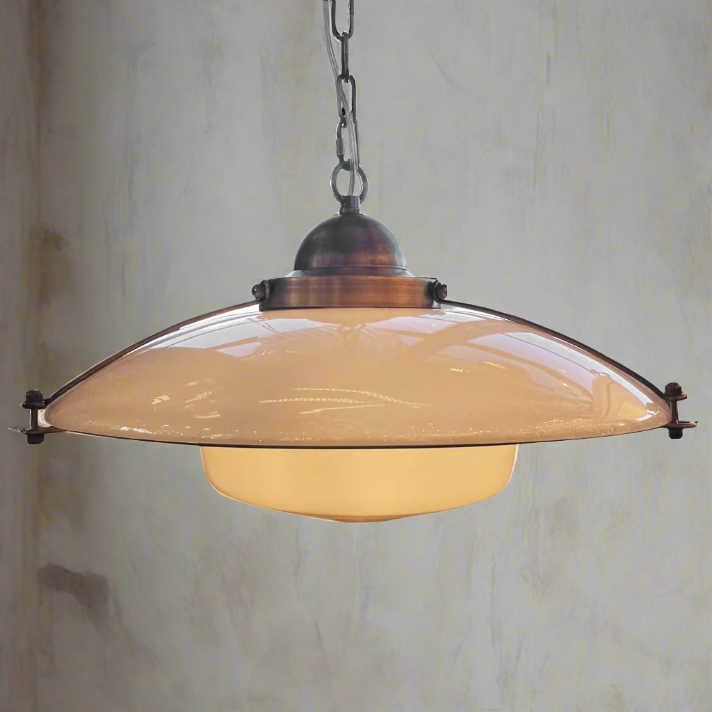 Vintage-style pendant light with beige shade against a textured wall.