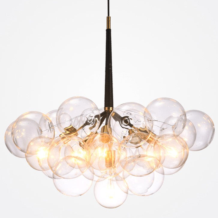 Modern chandelier with clear glass bubbles and gold accents on a white background
