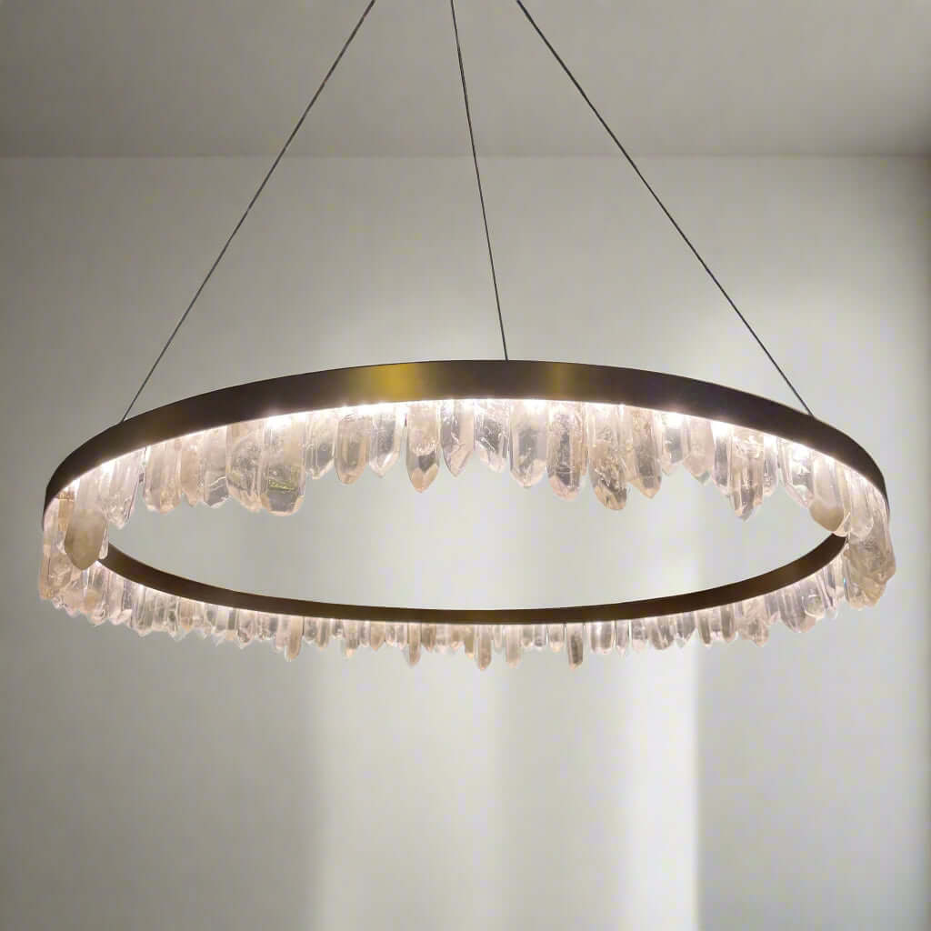 Antique Brass finished pendant light with natural crystals directed in various directions, suspended from the ceiling.