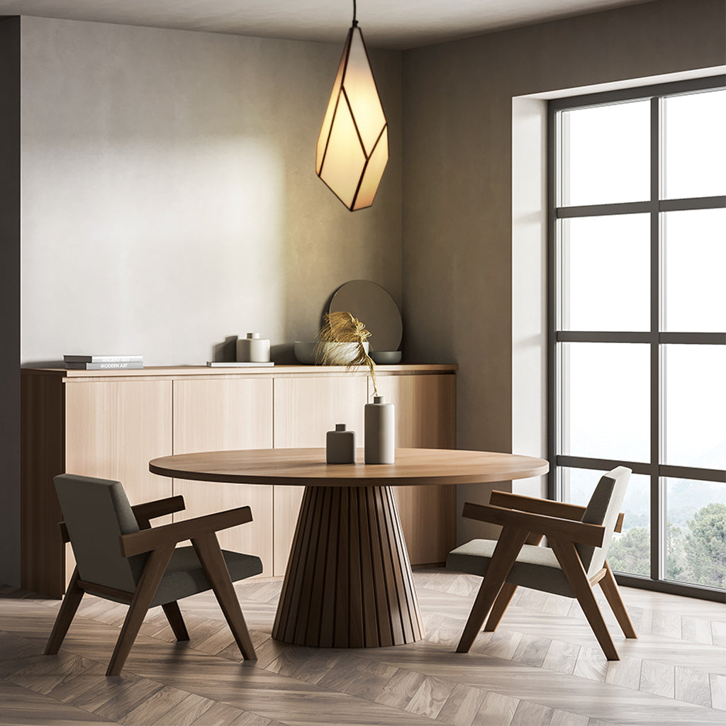 Modern dining room with wooden table and chairs, light fixture, and large window.
